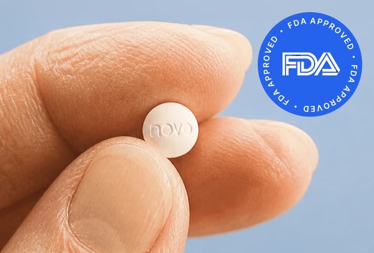 Hand holding an FDA-approved GLP-1 tablet